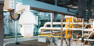 Interior of a factory with a security camera in focus.