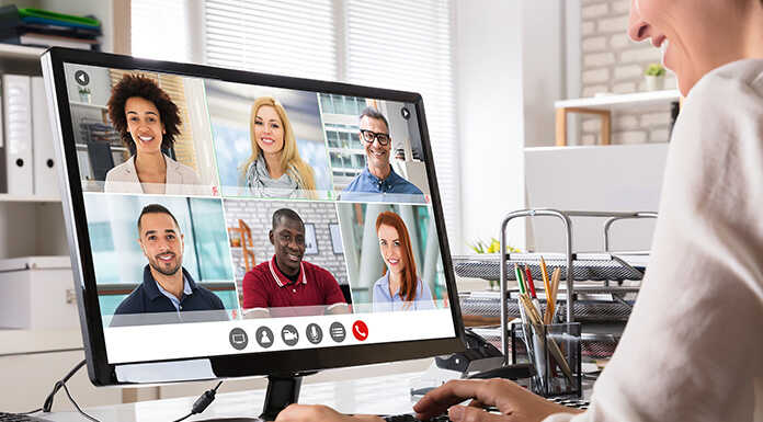 A manager speaking with her employees over video chat.